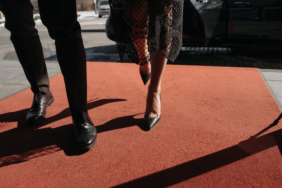 Stylish couple on red carpet, showcasing fashion and elegance at a prestigious event
